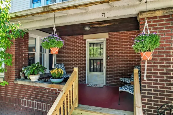 a front view of a house with plants