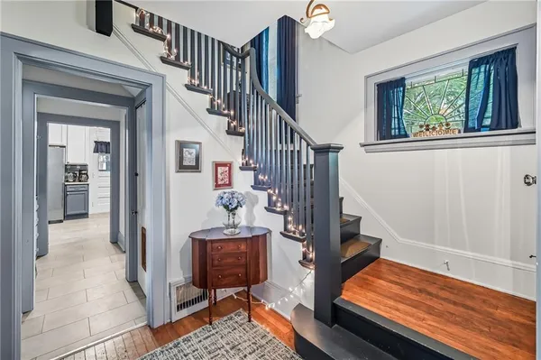 a view of entryway and hall with wooden floor