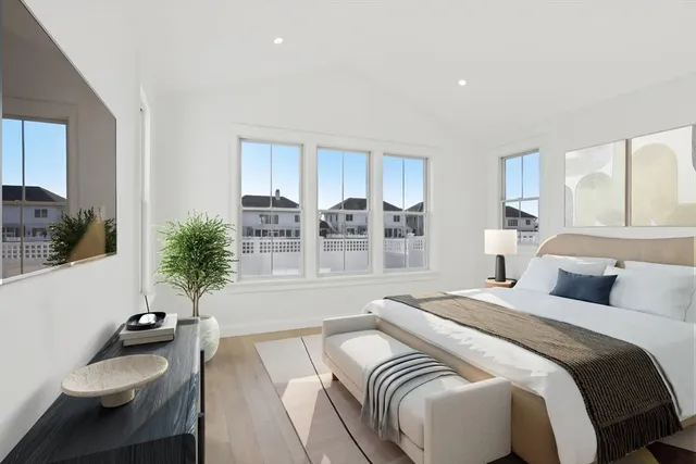 a bedroom with a bed and a table with potted plant