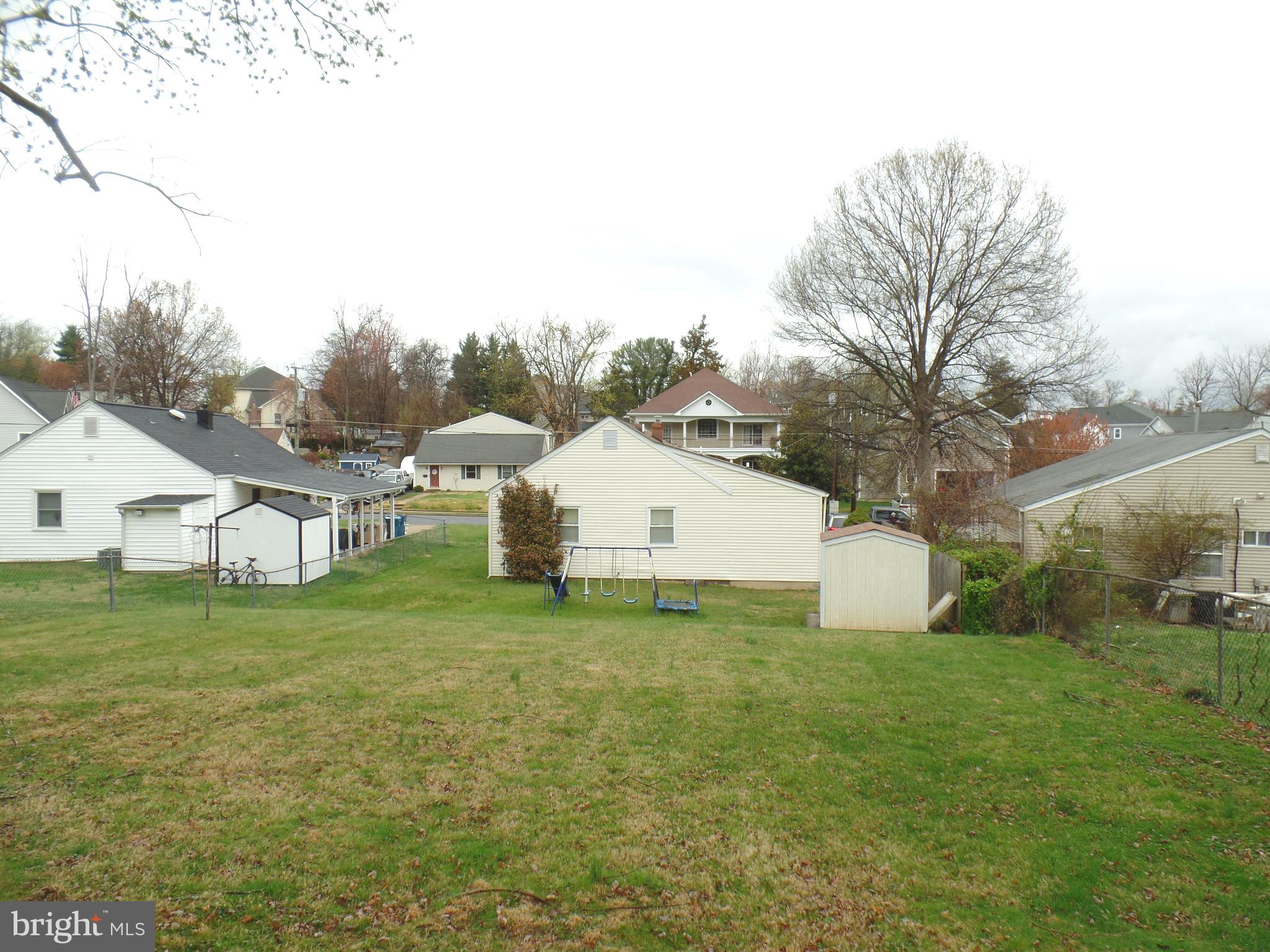 7403 Paxton Road Falls Church, VA 22043 - Photo 2 of 9 a white house that has a big yard and large trees
