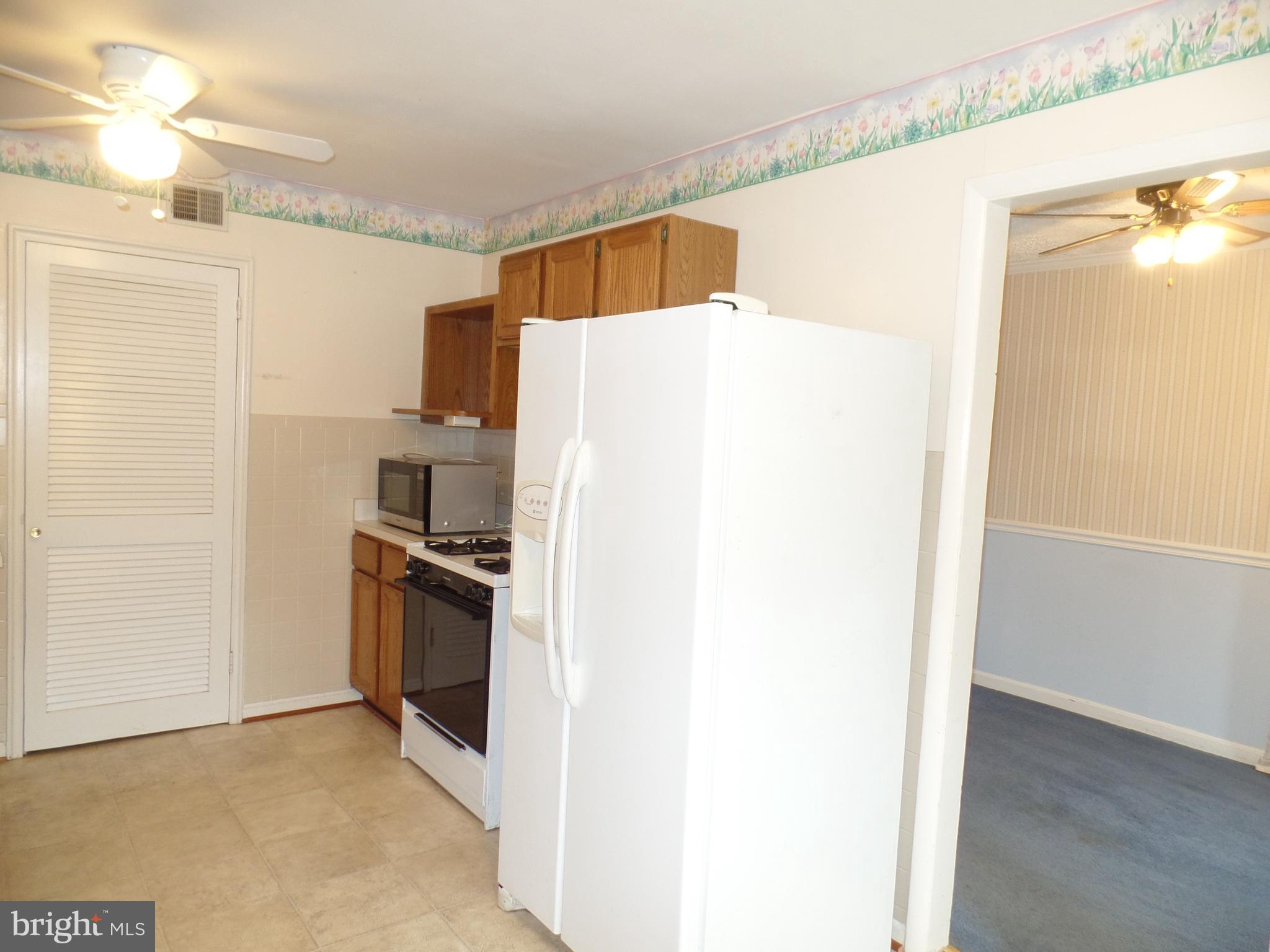 7403 Paxton Road Falls Church, VA 22043 - Photo 3 of 9 a kitchen with stainless steel appliances a refrigerator and a stove