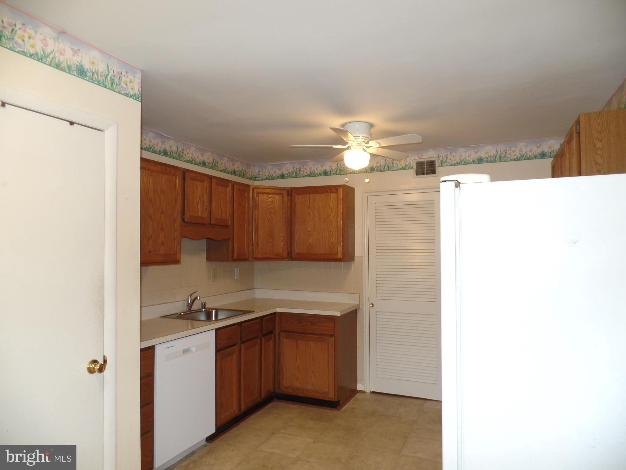 7403 Paxton Road Falls Church, VA 22043 - Photo 4 of 9 a kitchen with a sink cabinets and window