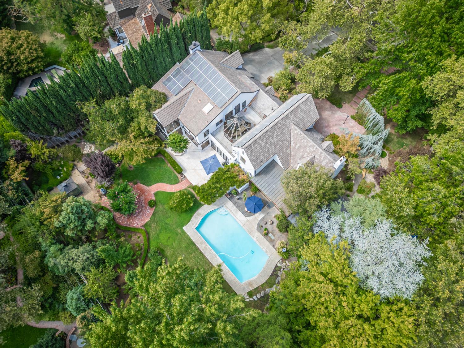 an aerial view of a house with a yard and lake view