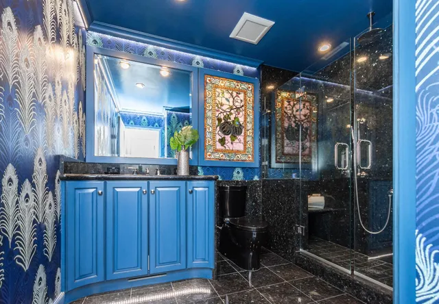 a bathroom with a mirror and a shower