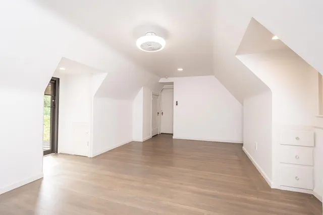 a view of an empty room with wooden floor