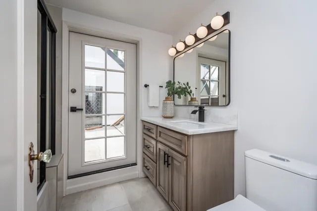 a bathroom with a sink a vanity and a mirror