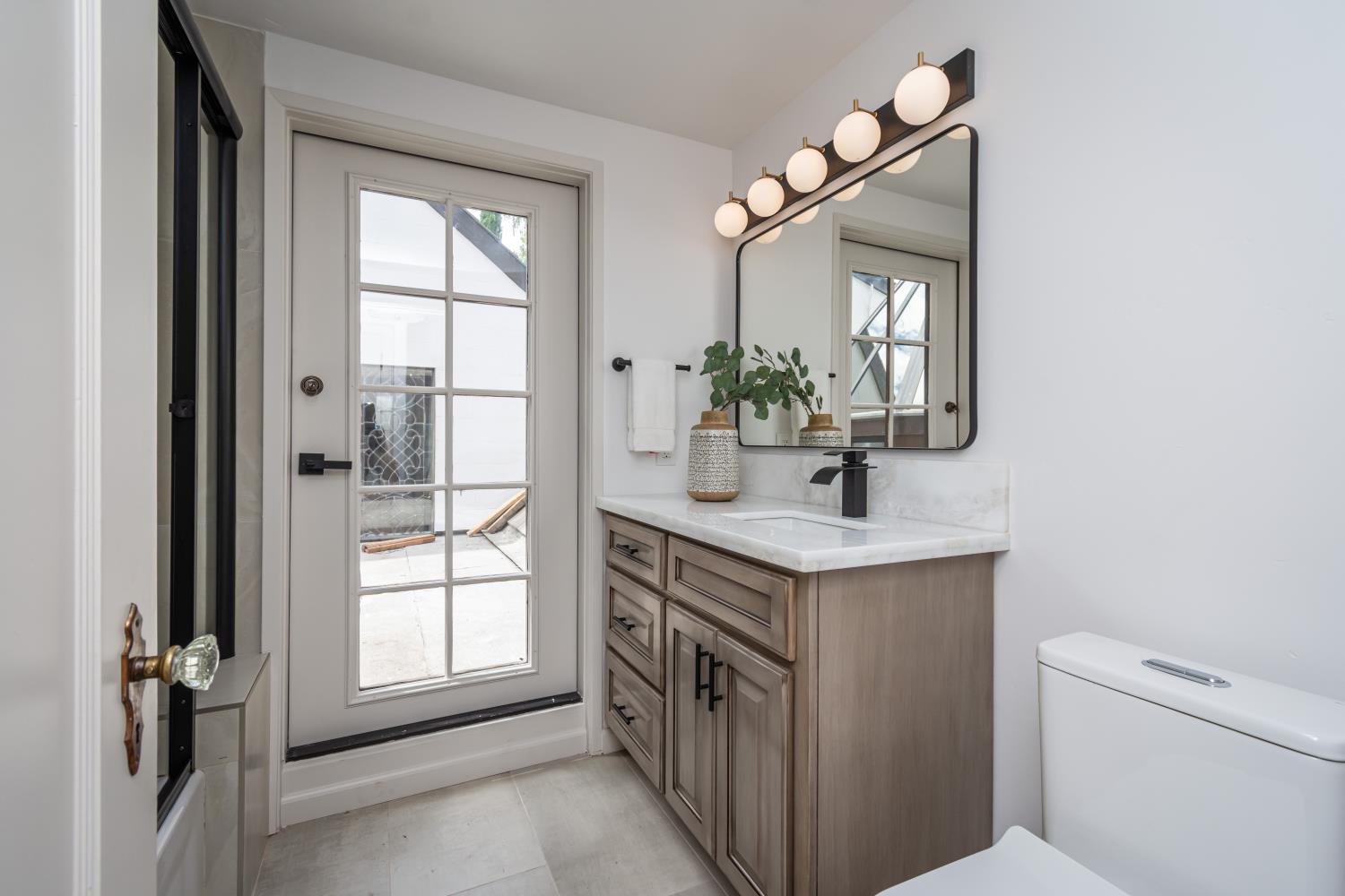 436 Hopkins Road Sacramento, CA 95864 - Photo 22 of 25 a bathroom with a sink a vanity and a mirror