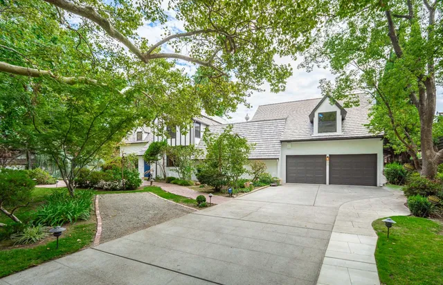 a front view of a house with a yard and a garage