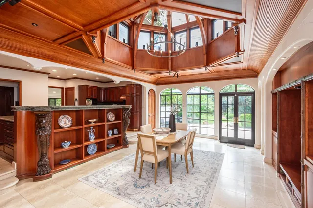 a dining room with furniture and a floor to ceiling window