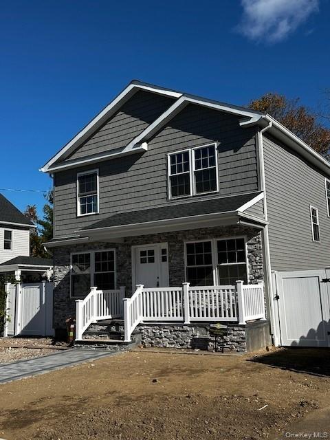 25 Maple Place Hicksville, NY 11801 - Photo 2 of 14 a front view of a house with a garage