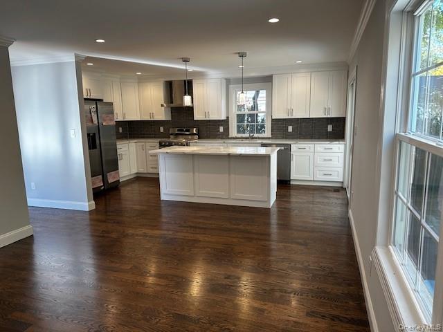 25 Maple Place Hicksville, NY 11801 - Photo 4 of 14 a kitchen with a refrigerator and white cabinets