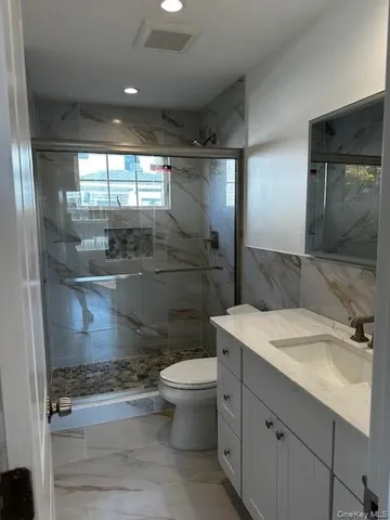 a bathroom with a sink toilet and shower