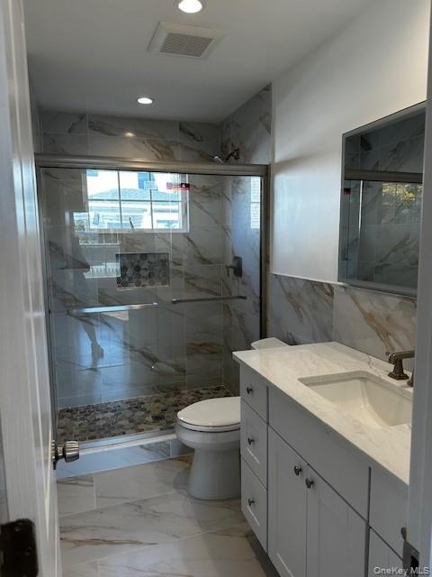 25 Maple Place Hicksville, NY 11801 - Photo 6 of 14 a bathroom with a sink toilet and shower