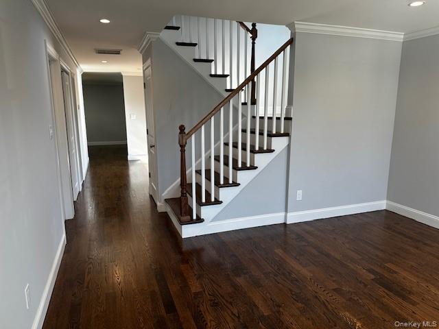 25 Maple Place Hicksville, NY 11801 - Photo 7 of 14 a view of a hallway with wooden floor and staircase
