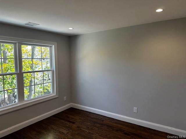 25 Maple Place Hicksville, NY 11801 - Photo 9 of 14 an empty room with wooden floor and windows