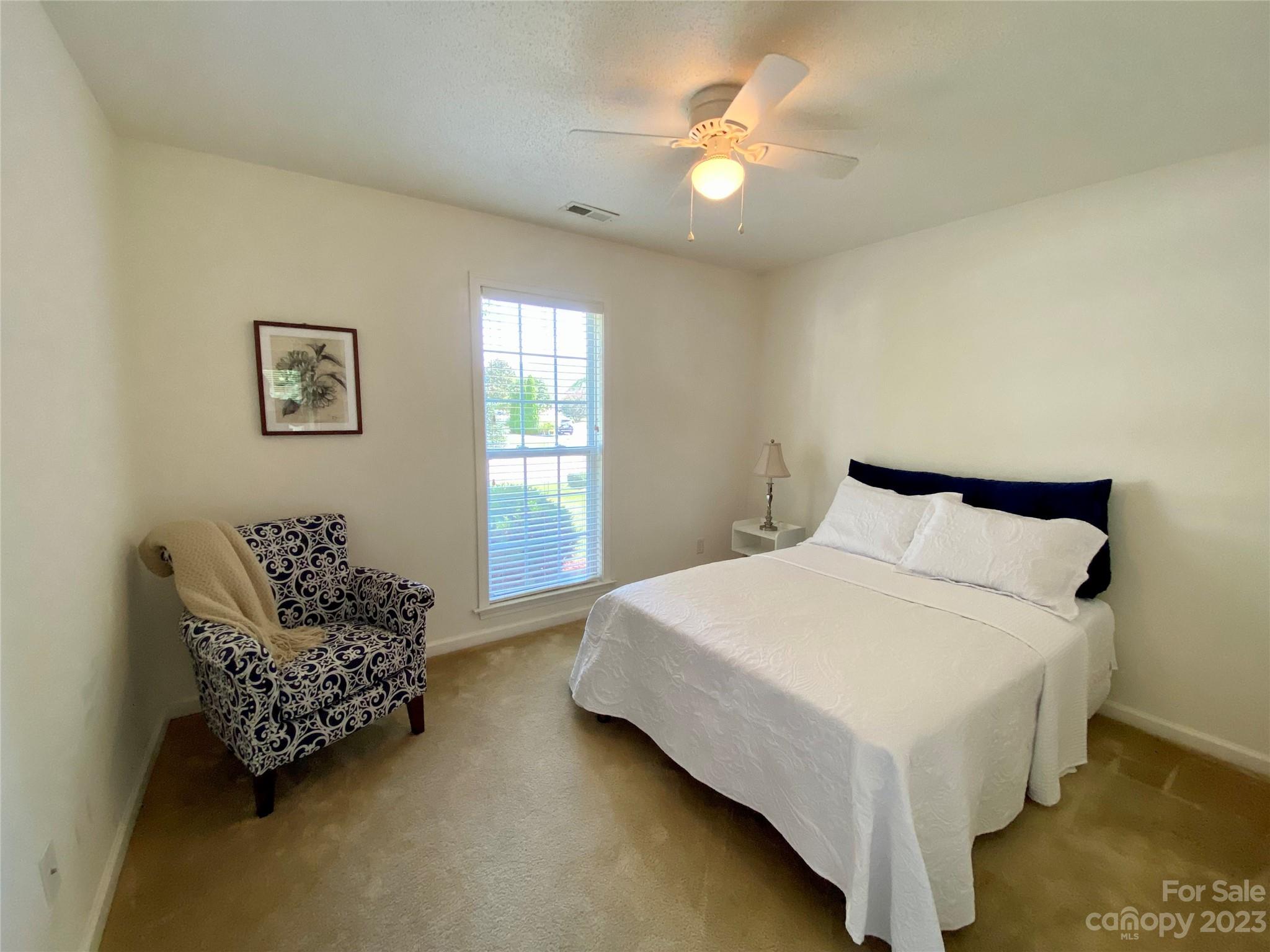 164 Cottage Ridge Road Fletcher, NC 28732 - Photo 17 of 23 a bedroom with a bed and a chandelier