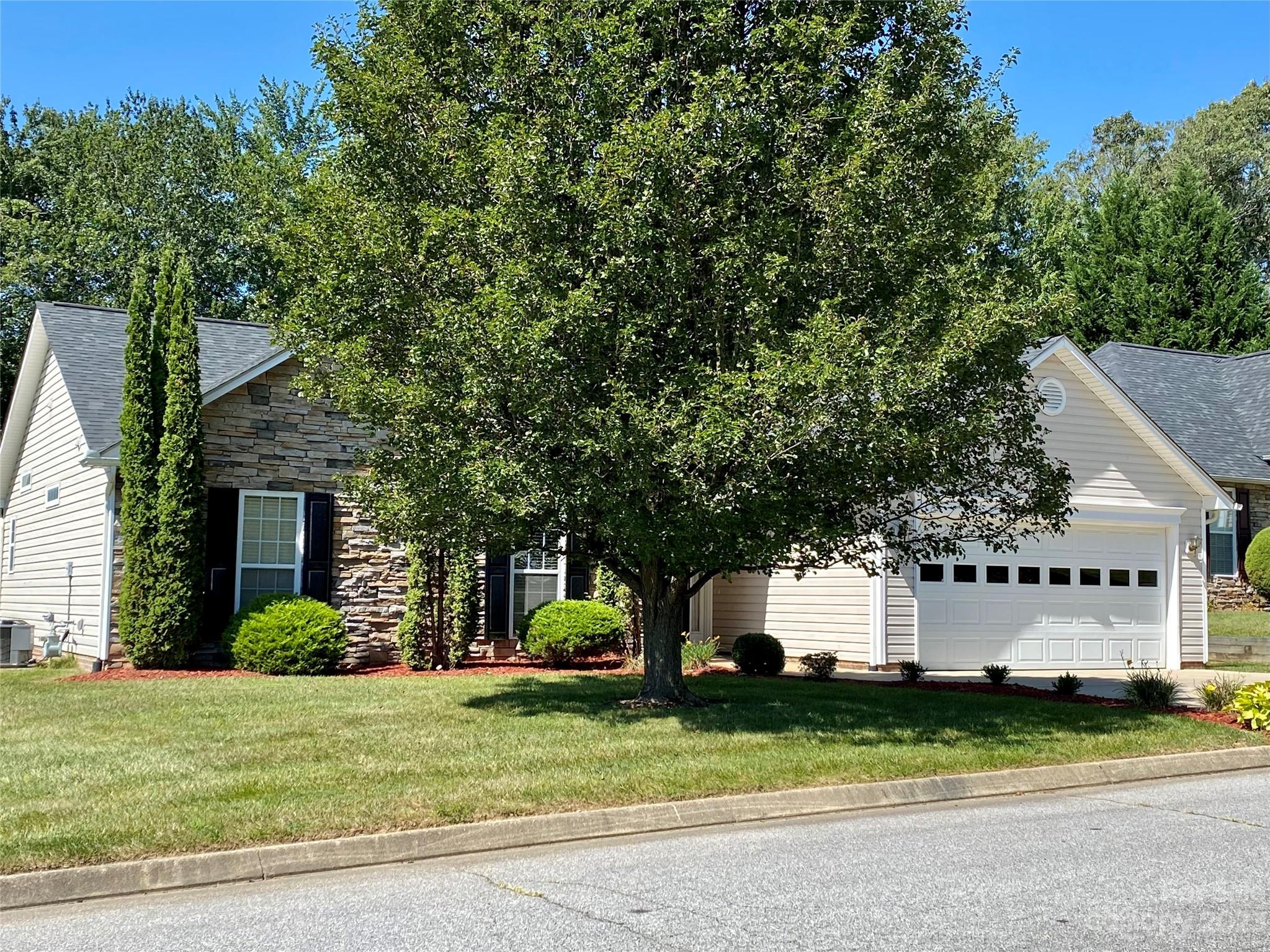 164 Cottage Ridge Road Fletcher, NC 28732 - Photo 23 of 23 a front view of a house with a garden and trees