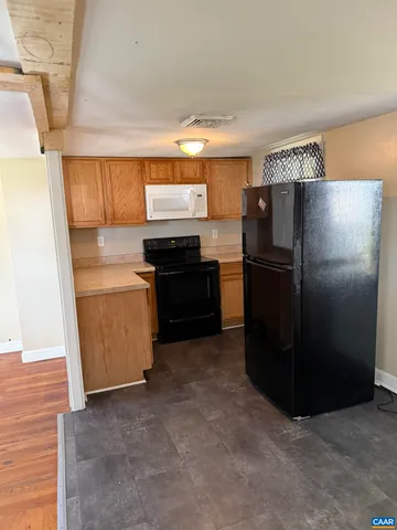 a kitchen with a refrigerator and a sink
