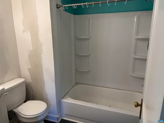 a bathroom with a toilet and a bathtub