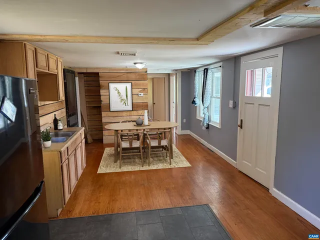 a living room with furniture rug and wooden floor