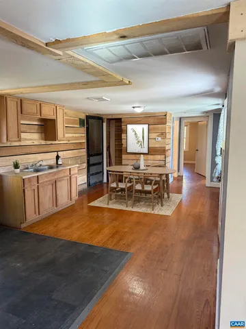a view of a kitchen with kitchen island a large counter space a sink and appliances