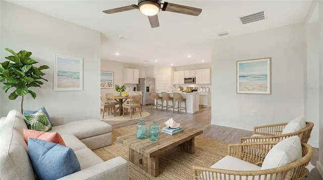 a living room with furniture and a dining room