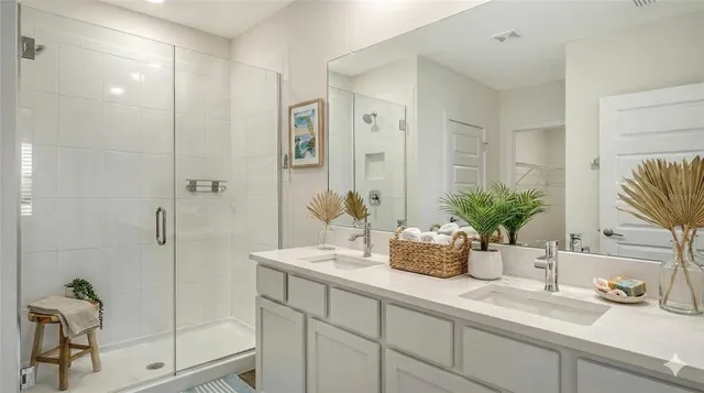 a bathroom with a shower sink and mirror