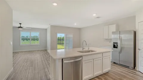 a kitchen with a sink appliances and cabinets
