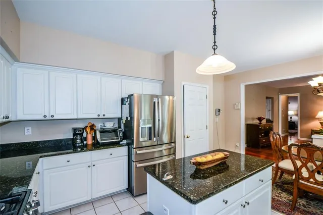 a kitchen with a dining table and chairs