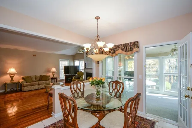 a view of a livingroom with furniture wooden floor and a floor to ceiling window