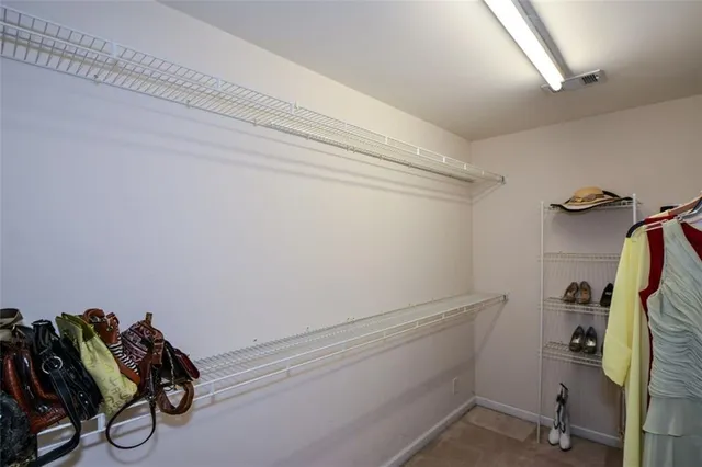 a bedroom with a bed and a lamp with the table