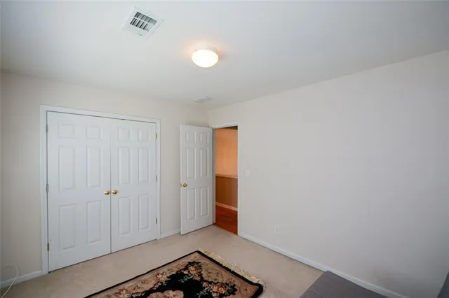 a view of a hallway to closet and a mirror
