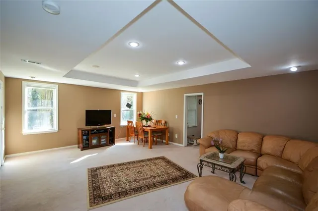 a aerial view of a house with a yard table and chairs