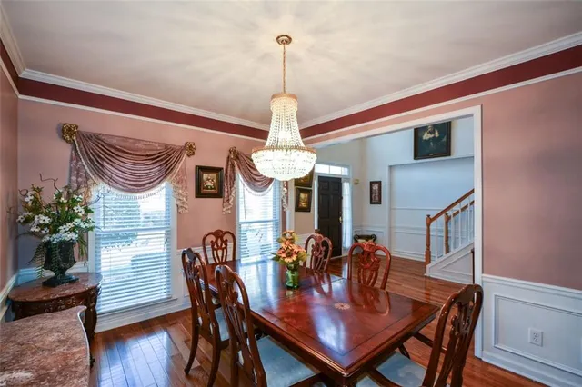 a view of a hallway with wooden floor and closet