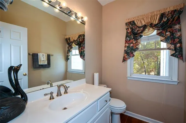 a bedroom with a bed and a lamp next to a window