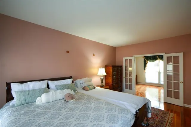 an empty room with wooden floor and a window