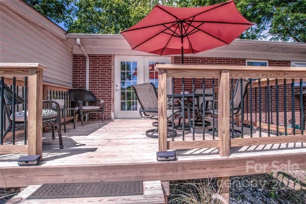 406 Fieldstone Road Mooresville, NC 28115 - Photo 14 of 43 a patio with a table and chairs under an umbrella
