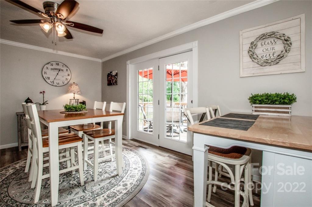 406 Fieldstone Road Mooresville, NC 28115 - Photo 24 of 43 a view of a dining room with furniture window and wooden floor