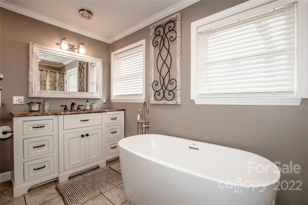 406 Fieldstone Road Mooresville, NC 28115 - Photo 36 of 43 a bathroom with a granite countertop sink mirror bathtub and next to a window