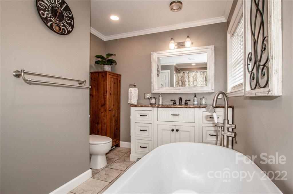 406 Fieldstone Road Mooresville, NC 28115 - Photo 40 of 43 a bathroom with a sink a toilet and a mirror