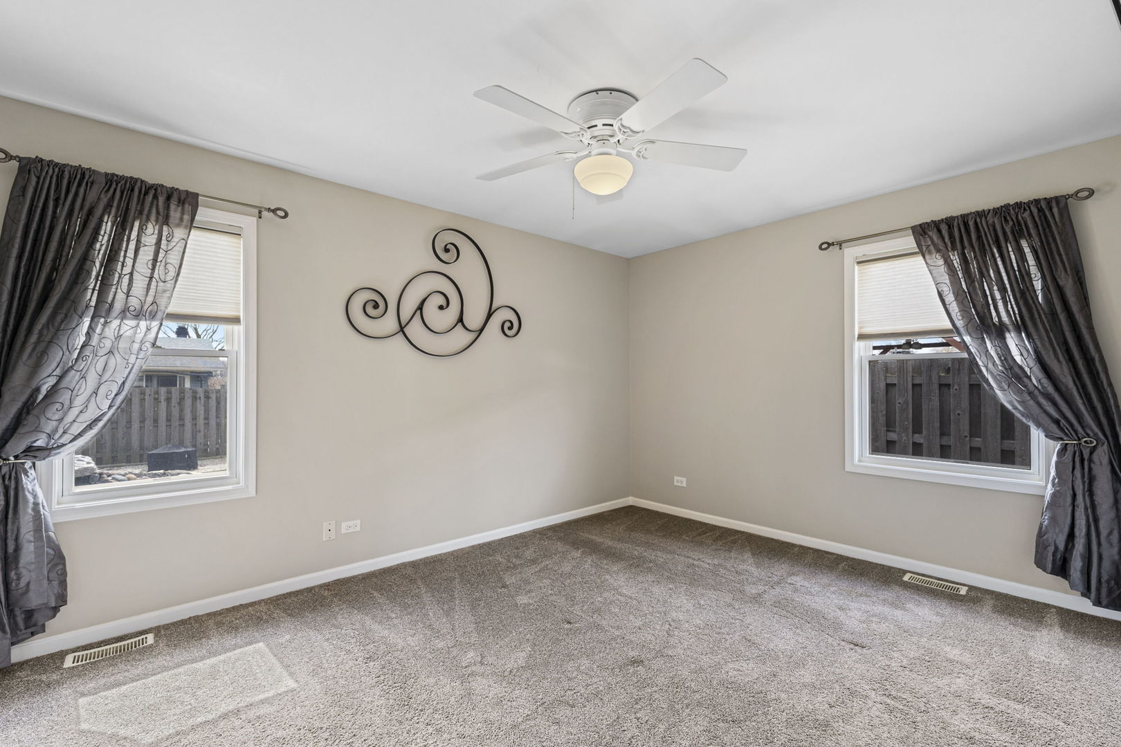 61 Avon Road Elk Grove Village, IL 60007 - Photo 15 of 41 an empty room with windows and fan