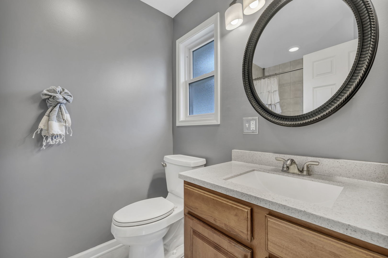 61 Avon Road Elk Grove Village, IL 60007 - Photo 16 of 41 a bathroom with a granite countertop toilet a sink and a mirror
