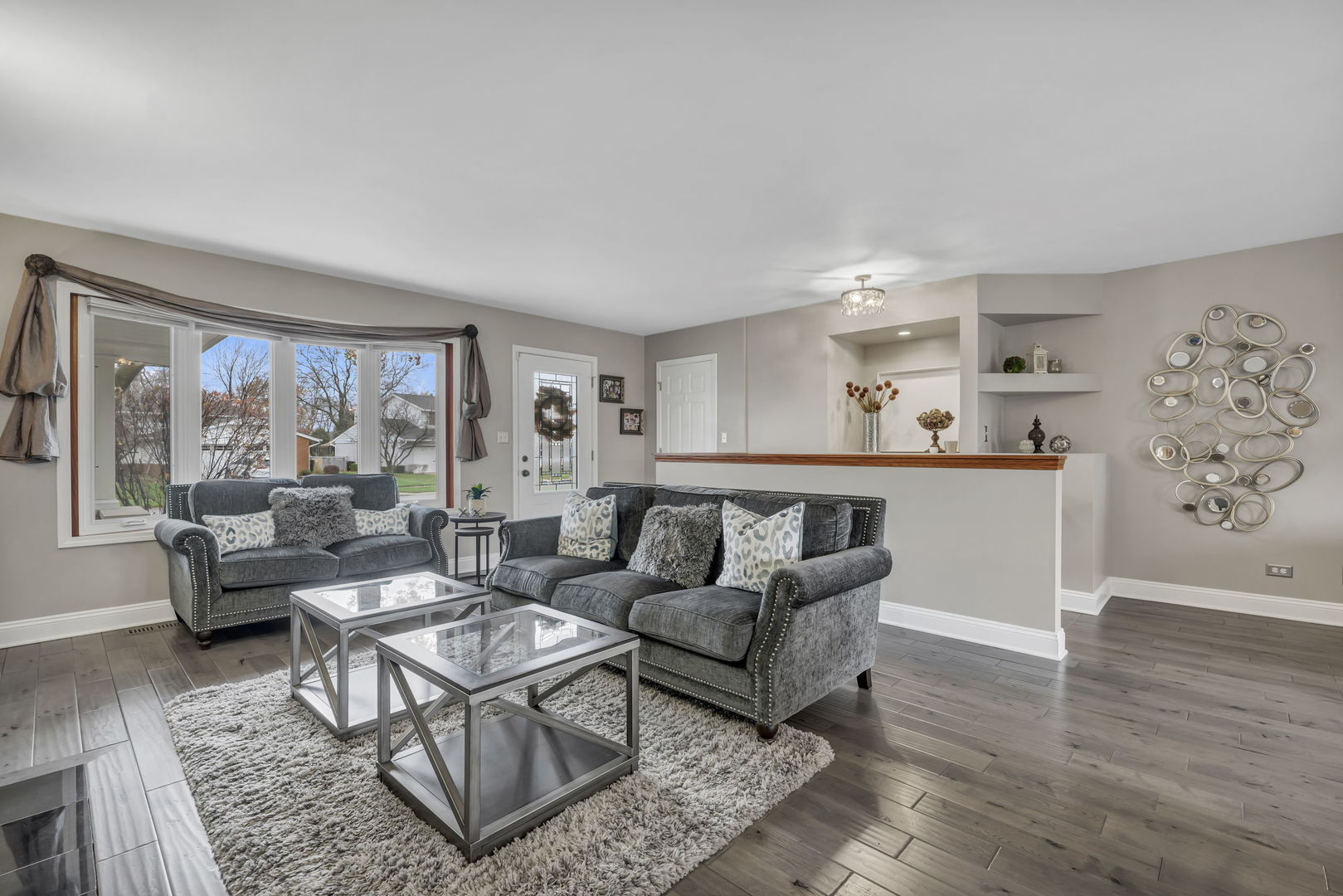61 Avon Road Elk Grove Village, IL 60007 - Photo 2 of 41 a living room with furniture and a large window