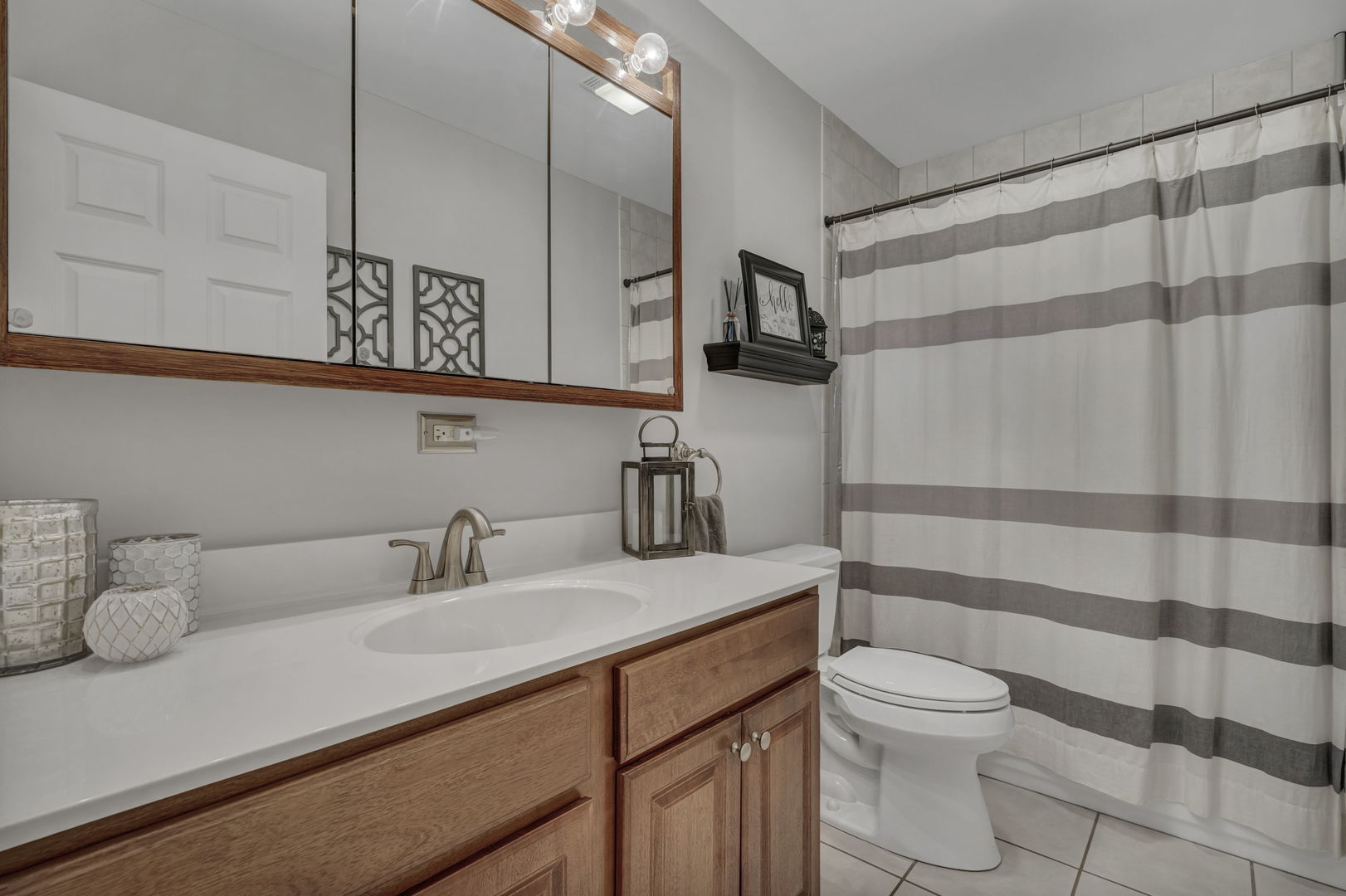 61 Avon Road Elk Grove Village, IL 60007 - Photo 22 of 41 a bathroom with a sink a toilet and shower curtain