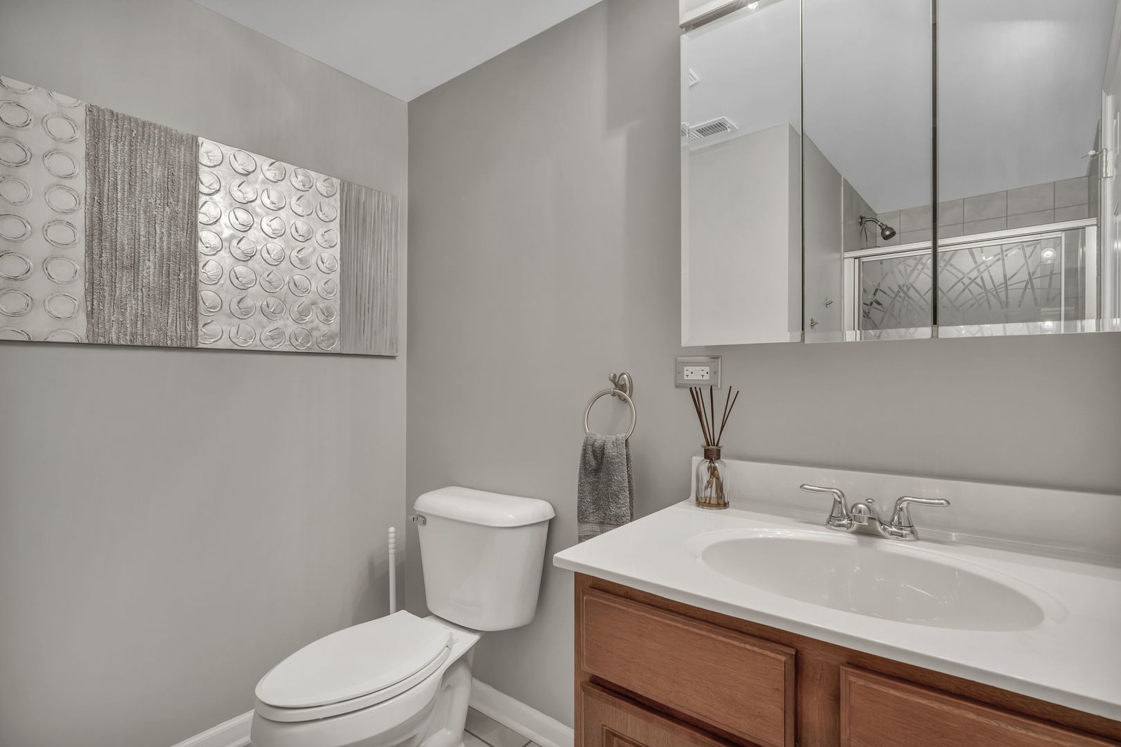 61 Avon Road Elk Grove Village, IL 60007 - Photo 30 of 41 a bathroom with a sink a toilet and mirror