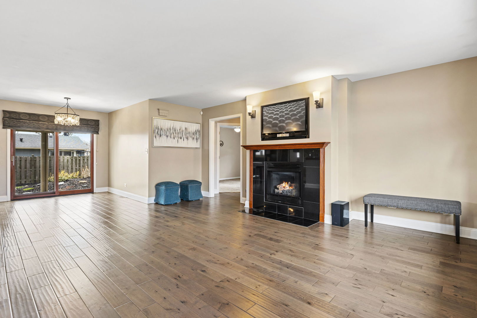 61 Avon Road Elk Grove Village, IL 60007 - Photo 4 of 41 a view of an empty room with wooden floor and a fireplace