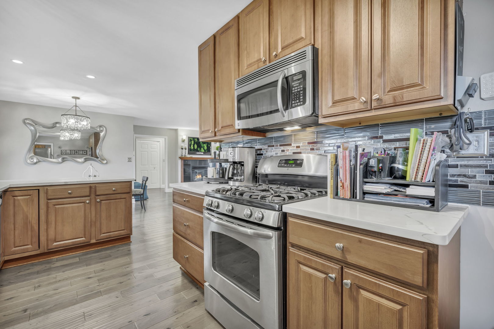 61 Avon Road Elk Grove Village, IL 60007 - Photo 8 of 41 a kitchen with stainless steel appliances granite countertop a stove top oven a sink dishwasher and cabinets with wooden floor