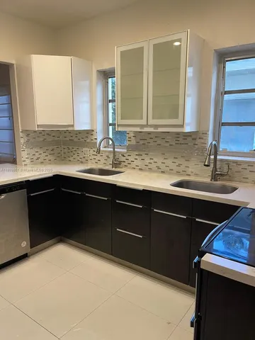 a kitchen with a sink and a wooden cabinets