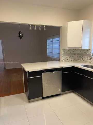 a kitchen with stainless steel appliances a sink and a stove