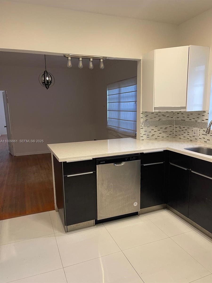 330 West 46th Street, Unit 1 Miami Beach, FL 33140 - Photo 3 of 3 a kitchen with stainless steel appliances a sink and a stove